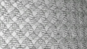 Interwoven metallic wireframes create a lattice-like pattern. The cables form a complex, repeating geometric structure, giving the impression of a mesh or net. The overall design is symmetrical and organized, producing a three-dimensional visual effect.