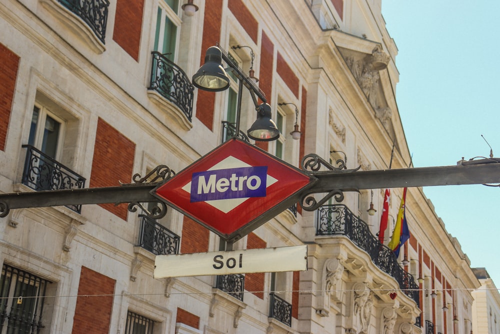 a metro sign hanging off the side of a building