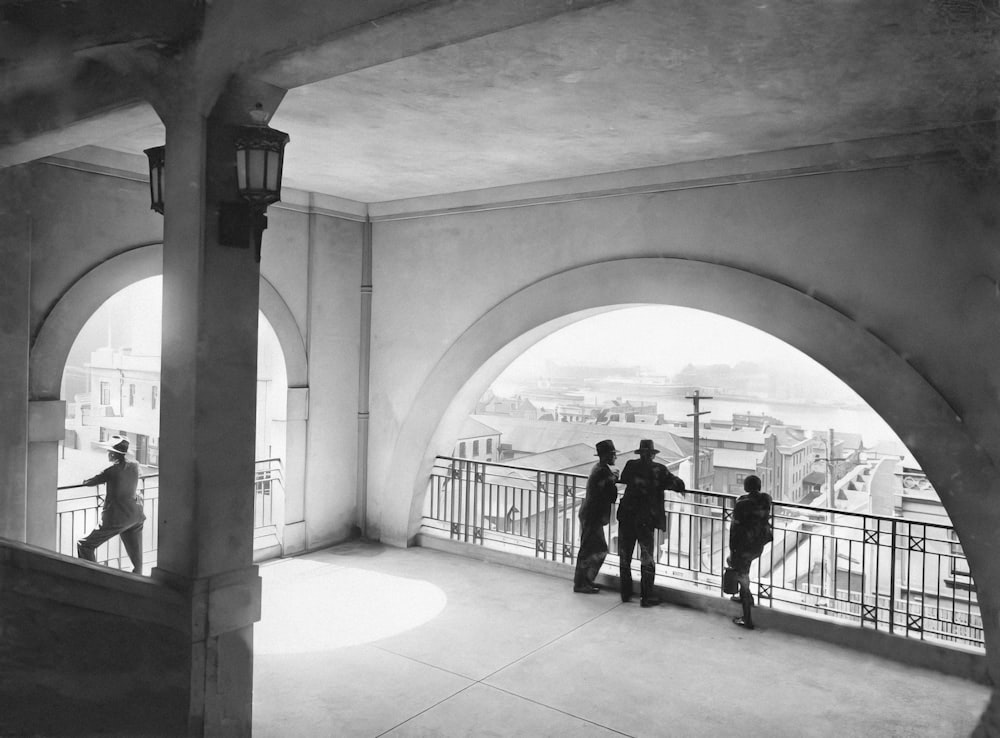 a group of people standing on top of a balcony