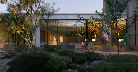 A sleek, modern sunroom with expansive glass panels overlooking a lush villa garden at sunset.