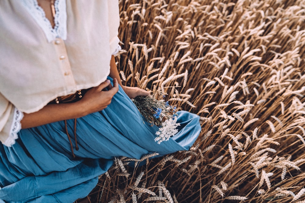 a woman standing in a field of wheat