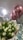 Bright floral arrangement with balloons and chocolates on a clean white backdrop.