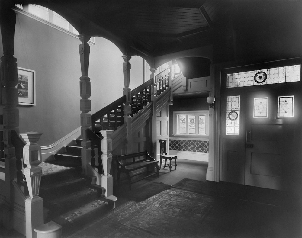 a black and white photo of a staircase in a house