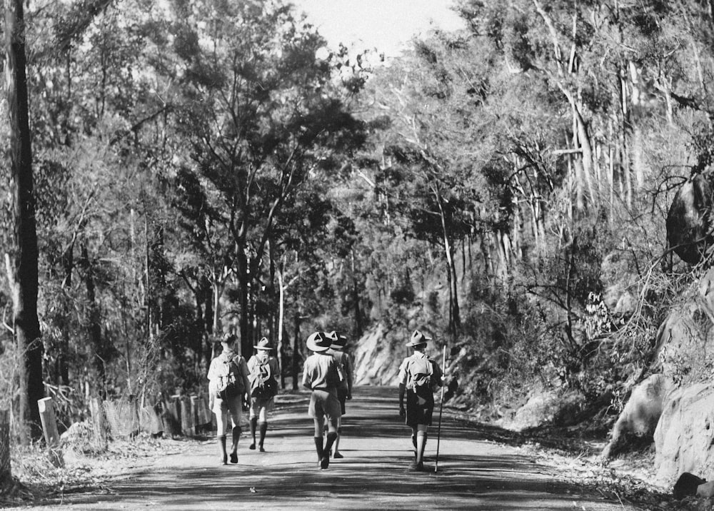 a group of people riding horses down a road
