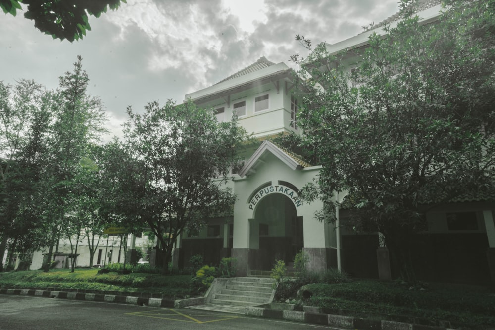 a large white building with a clock on the front of it