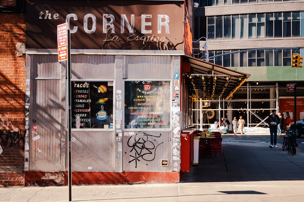 a corner restaurant with graffiti on the side of it