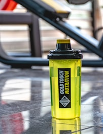 a yellow water bottle sitting on the ground
