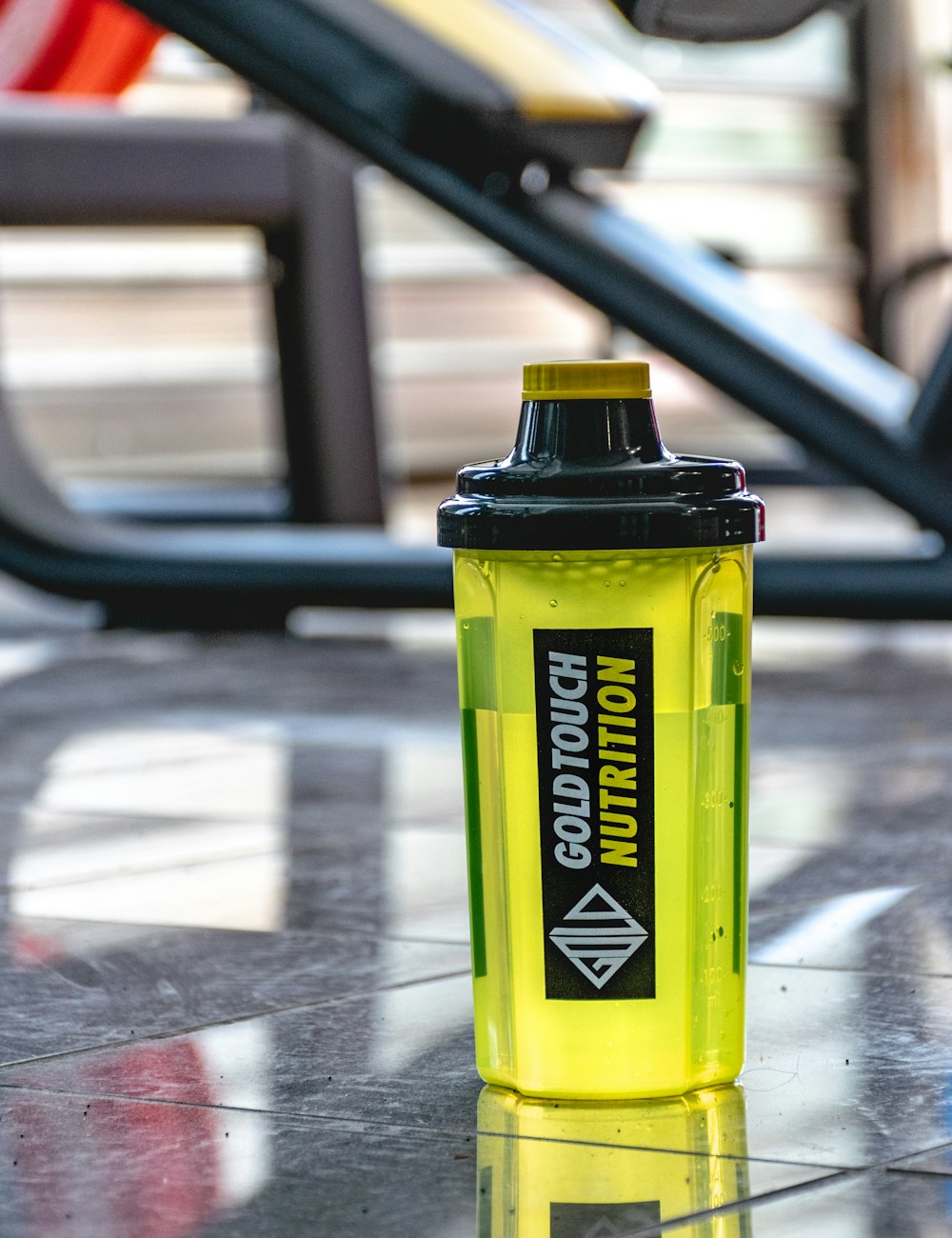 a yellow water bottle sitting on the ground