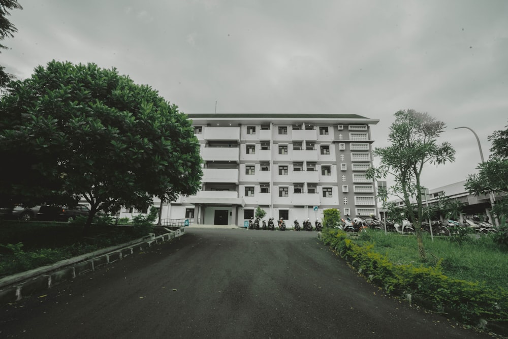 a large white building sitting on the side of a road