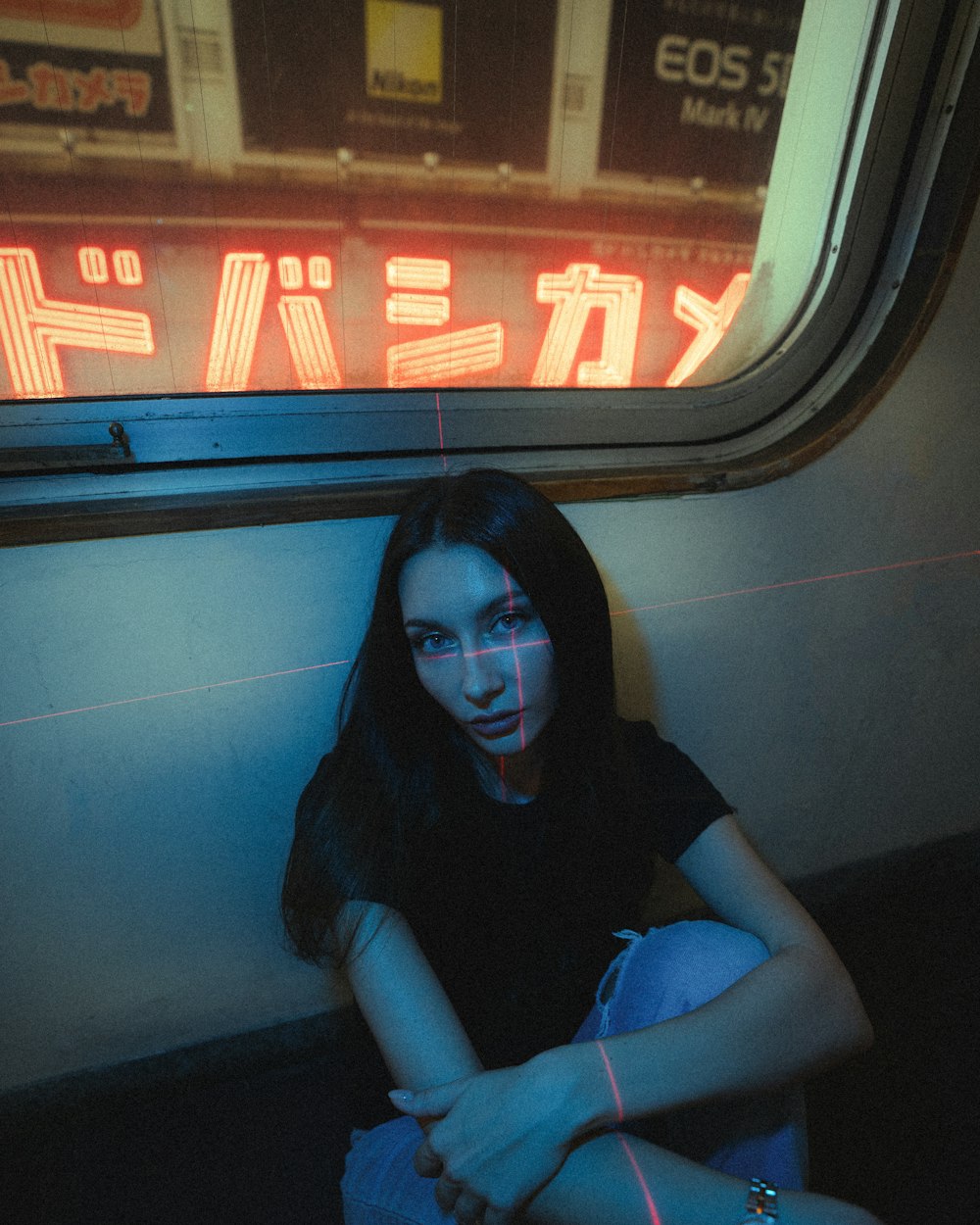 a woman sitting on a train looking out the window