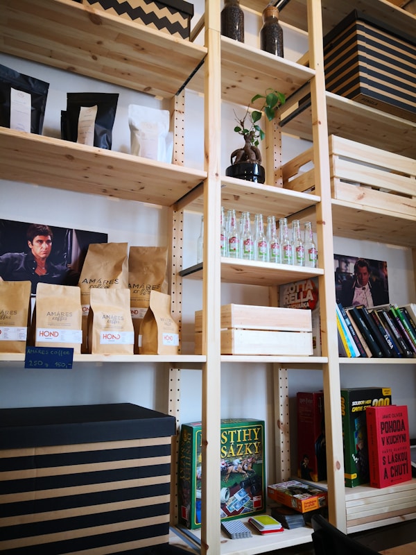 a bookshelf filled with lots of books and boxes