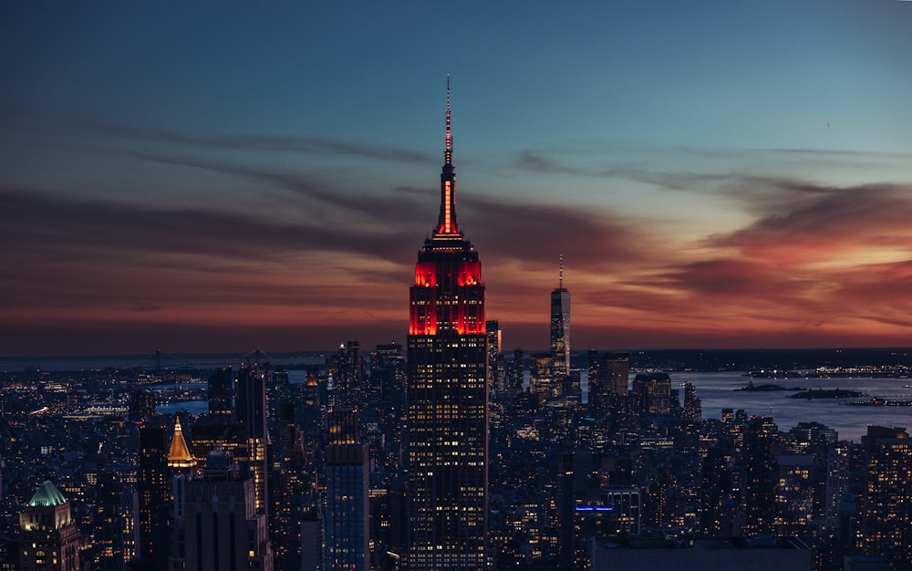 the empire building lit up in red and white