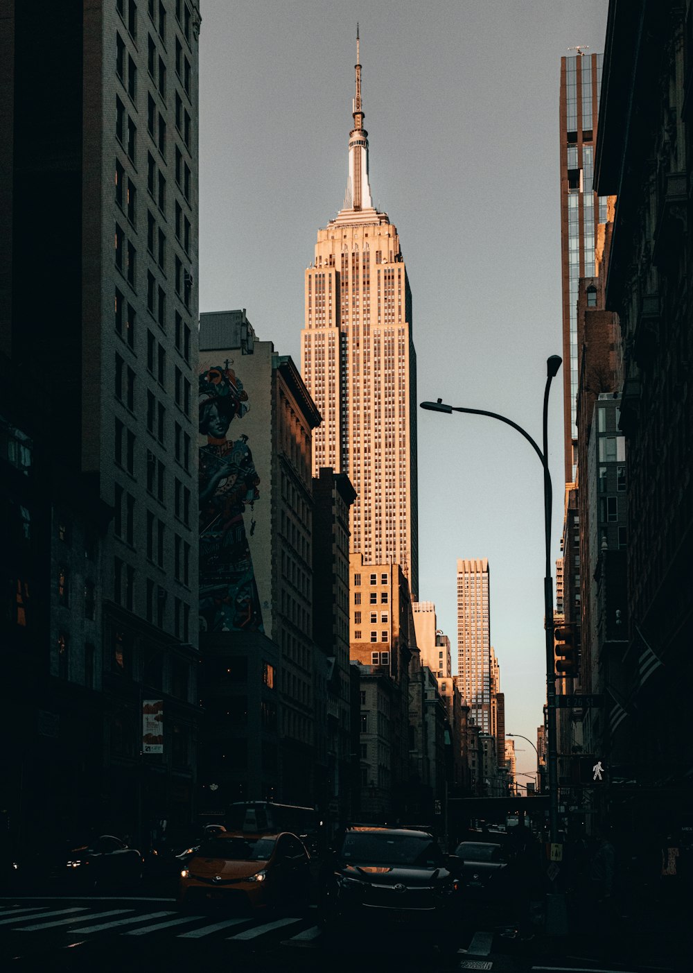 a tall building towering over a city filled with traffic