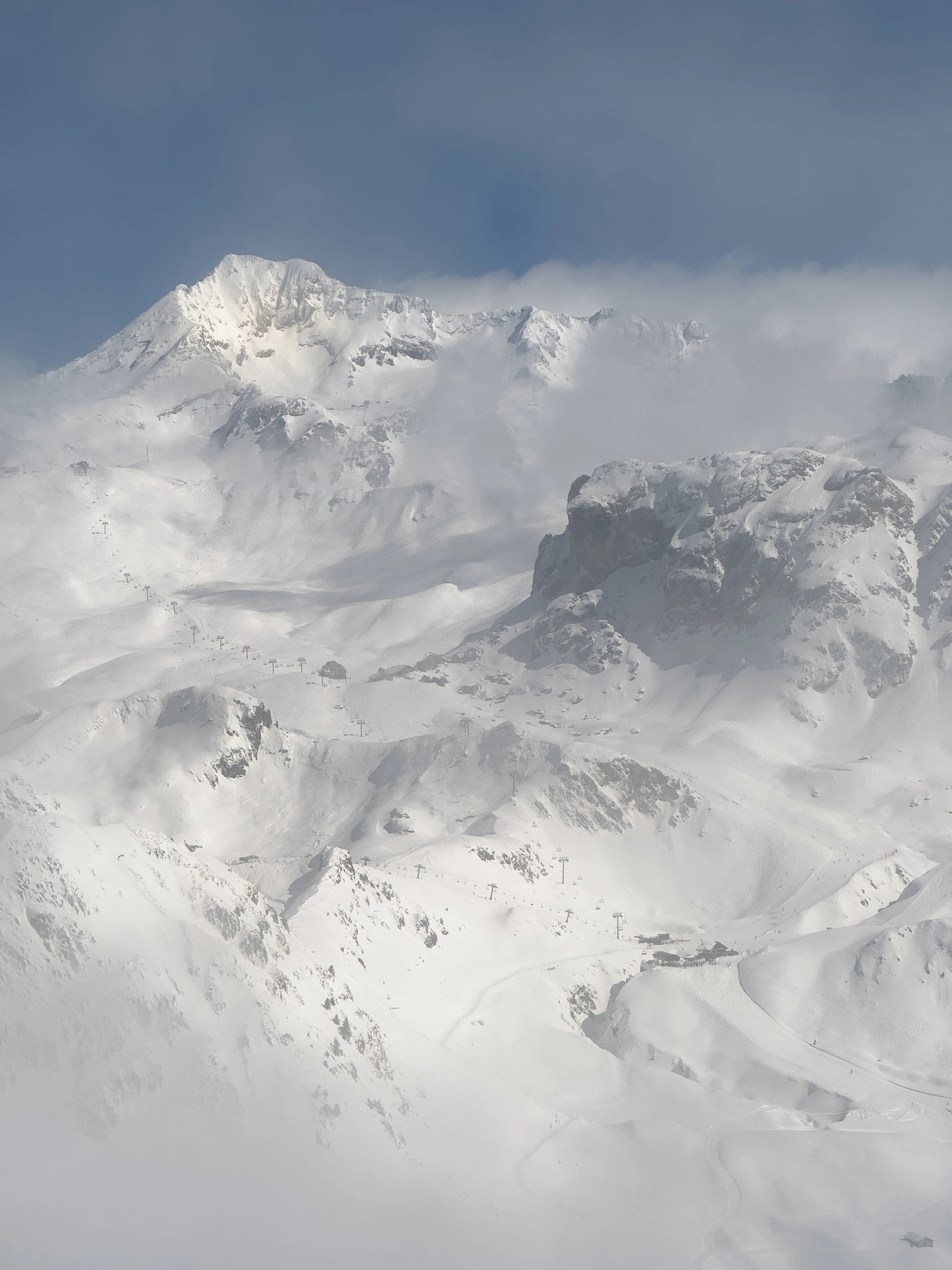 The snow-capped peaks of Gulmarg, showcasing a winter wonderland with skiers enjoying the slopes.