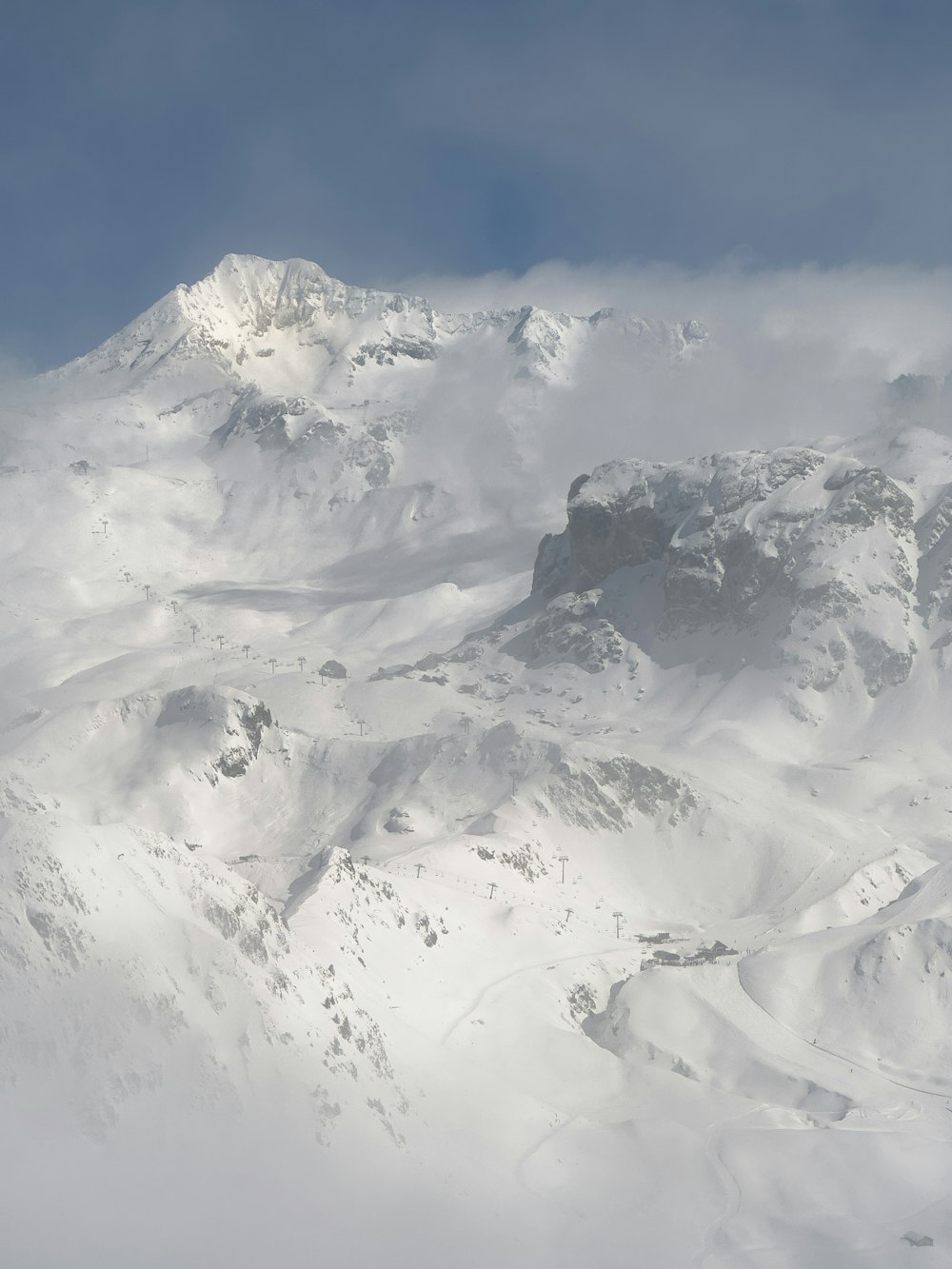 a mountain covered in snow under a blue sky