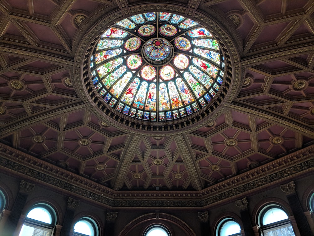 a circular stained glass window in the ceiling of a building