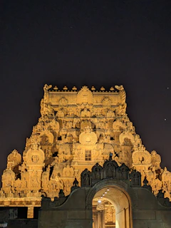 An ancient temple glowing under the evening sky, showcasing intricate carvings.
