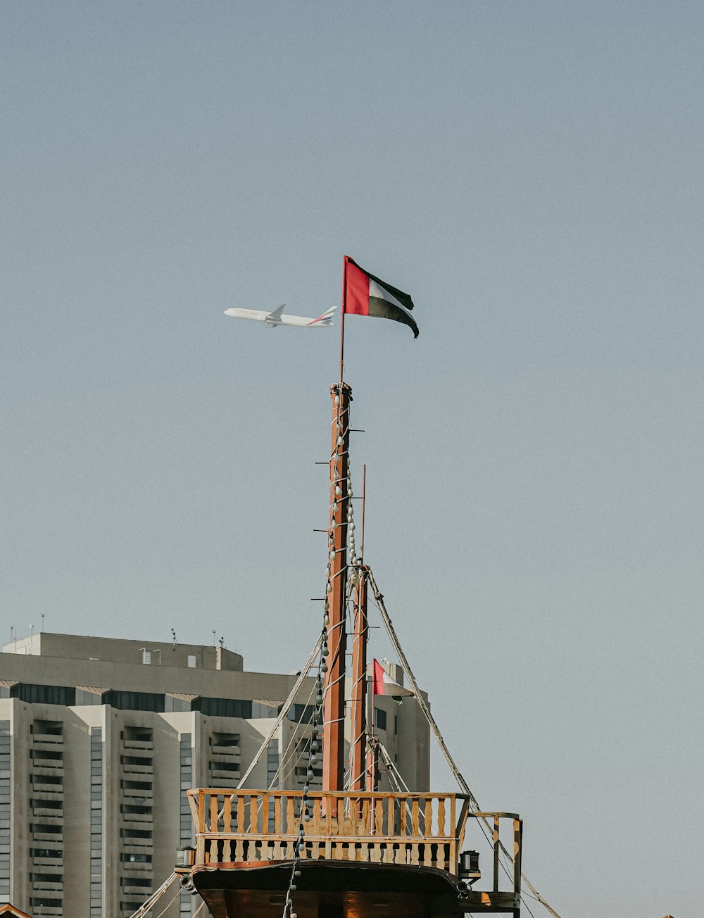 a tall ship with a flag on top of it