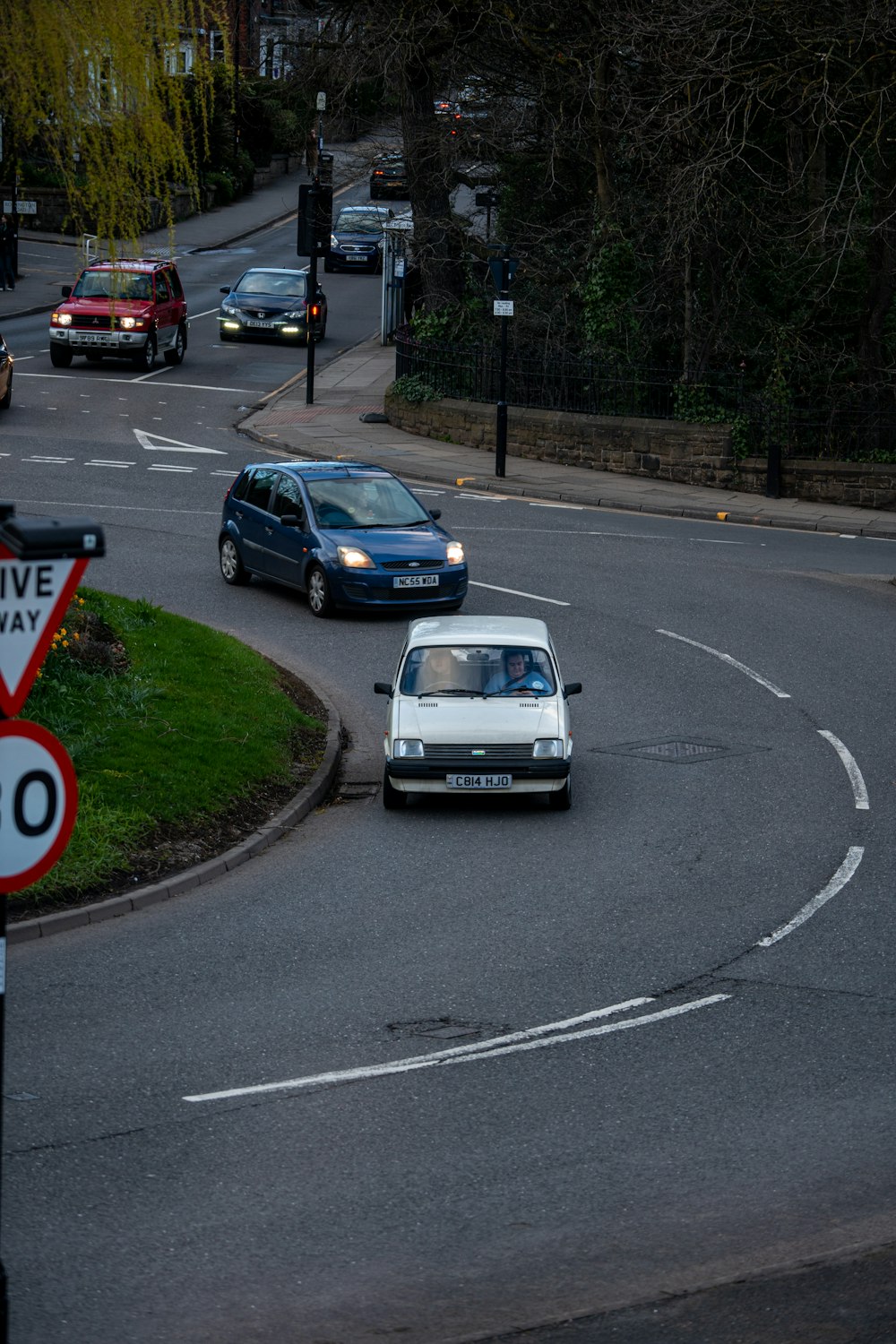 a white car driving down a curvy street