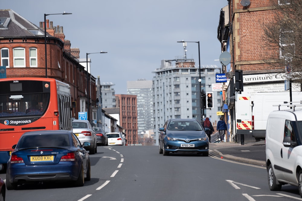 a city street filled with traffic next to tall buildings