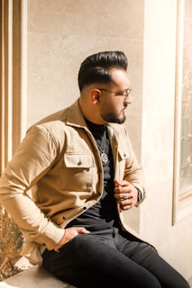 A stylish man’s haircut with a clean fade and well-groomed beard in natural light.