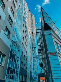 A cinematic view of sleek glass buildings in Brussels' European quarter under a clear sky.