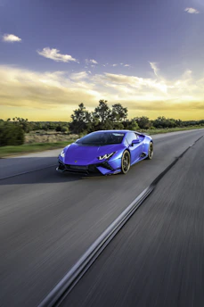 A sleek Bugatti speeding down a coastal highway with a Gulfstream jet soaring above in a clear blue sky.