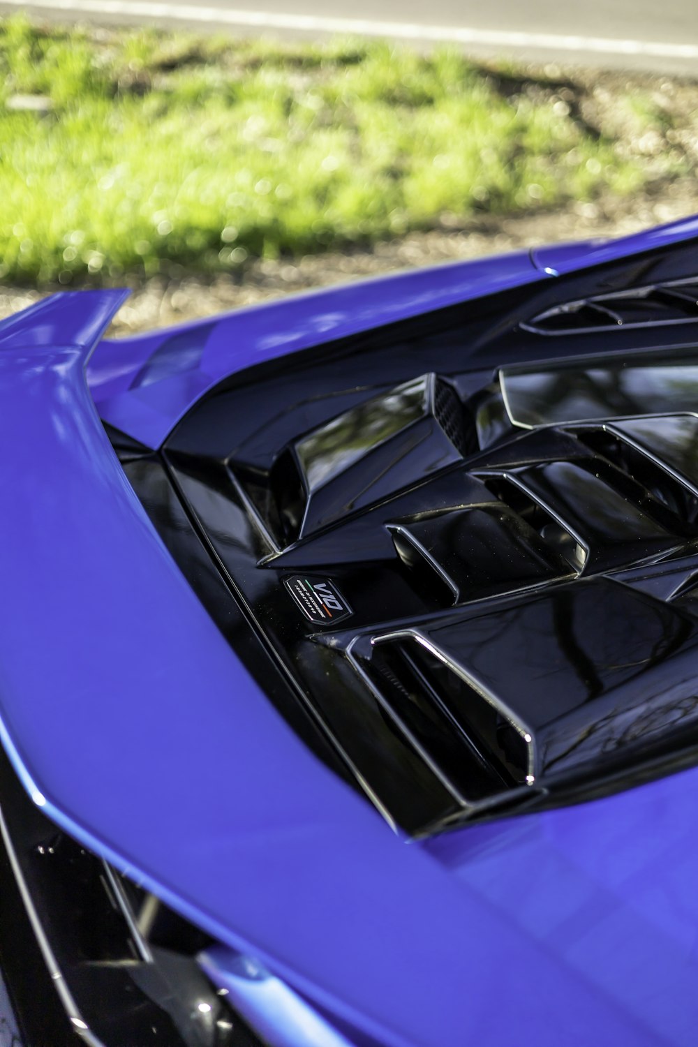 a close up of the hood of a blue sports car