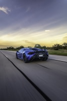 Dynamic shot of the Corvette C8 gliding smoothly on an open mountain road under dusk sky.