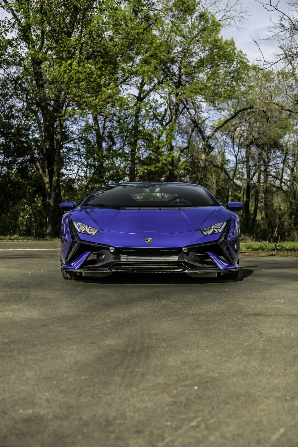 a blue sports car parked in a parking lot