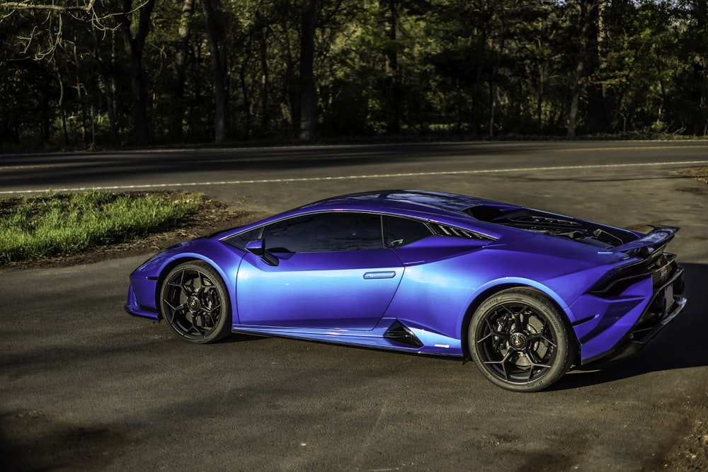 a blue sports car parked on the side of the road