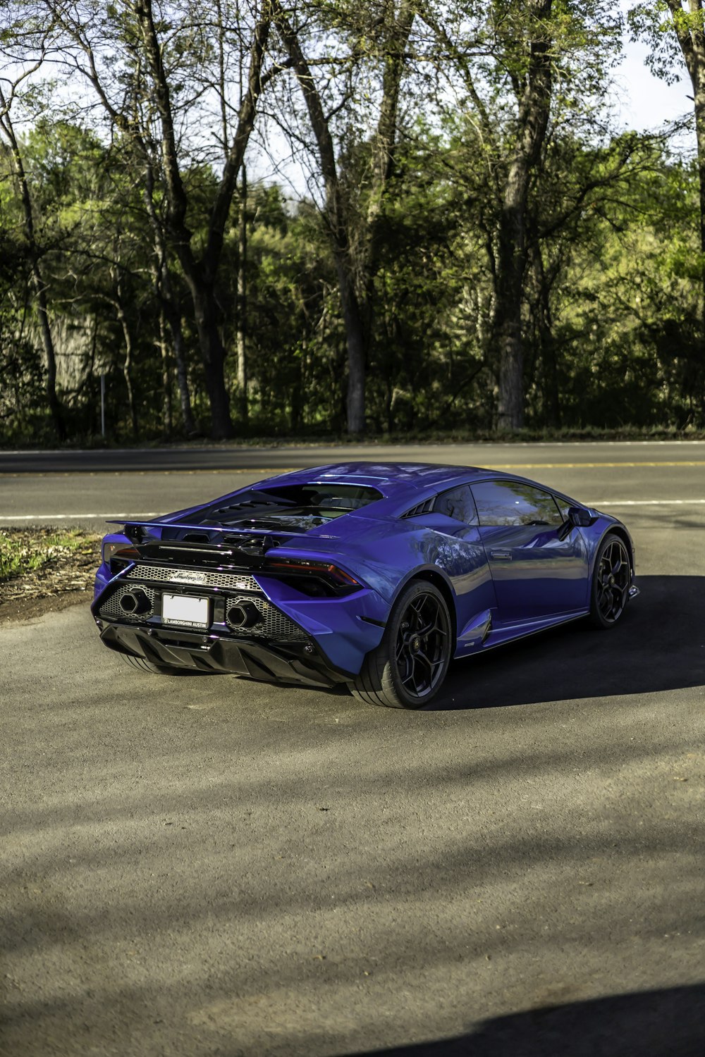 a blue sports car parked on the side of the road