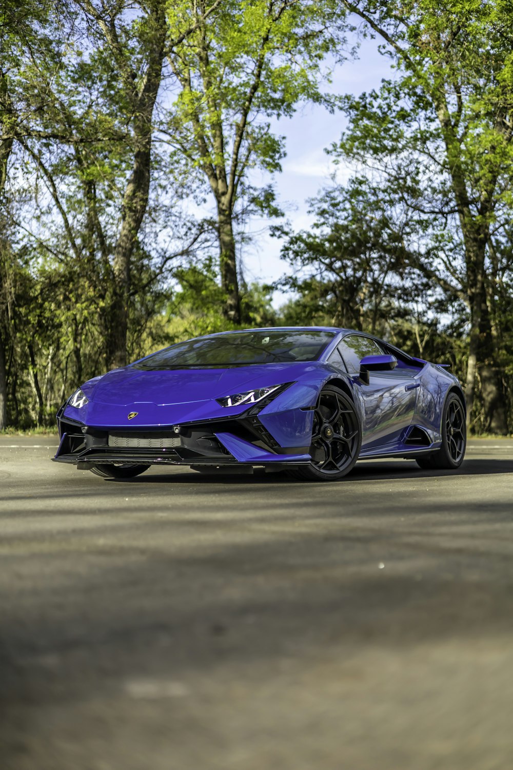 a blue sports car parked on the side of the road