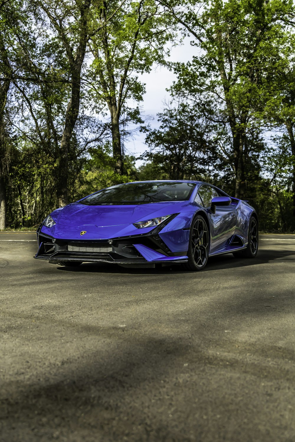 a blue sports car parked in a parking lot