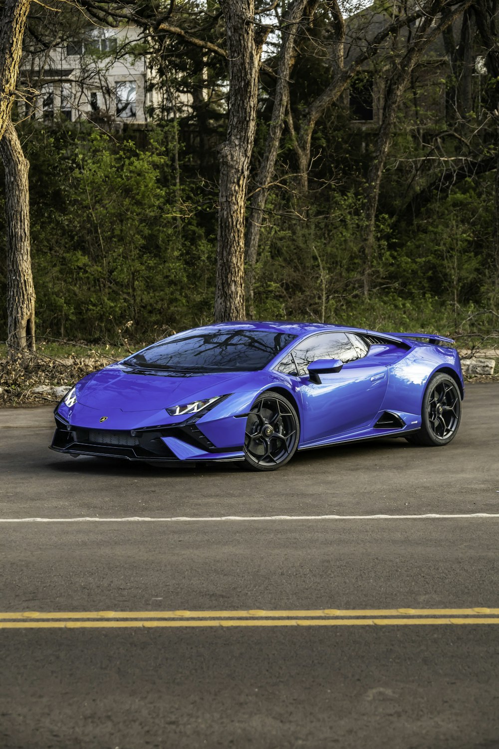 a blue sports car parked on the side of the road