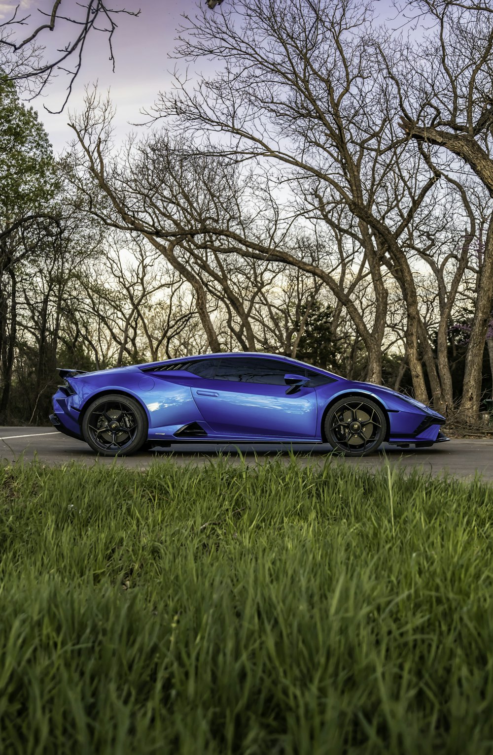 a blue sports car parked on the side of the road