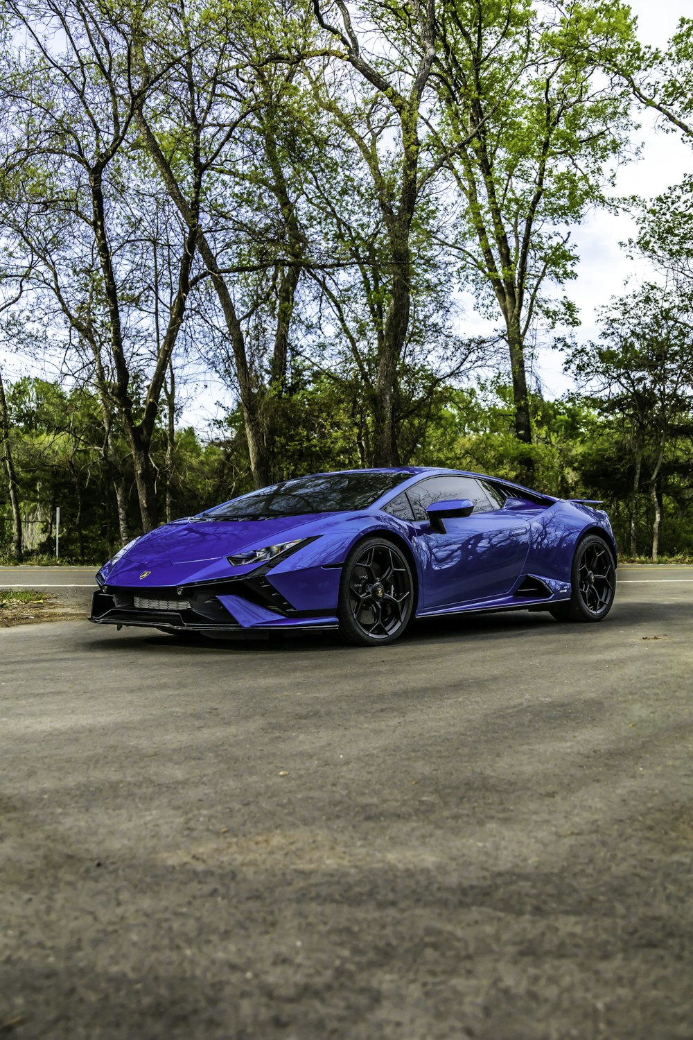 a blue sports car parked in a parking lot