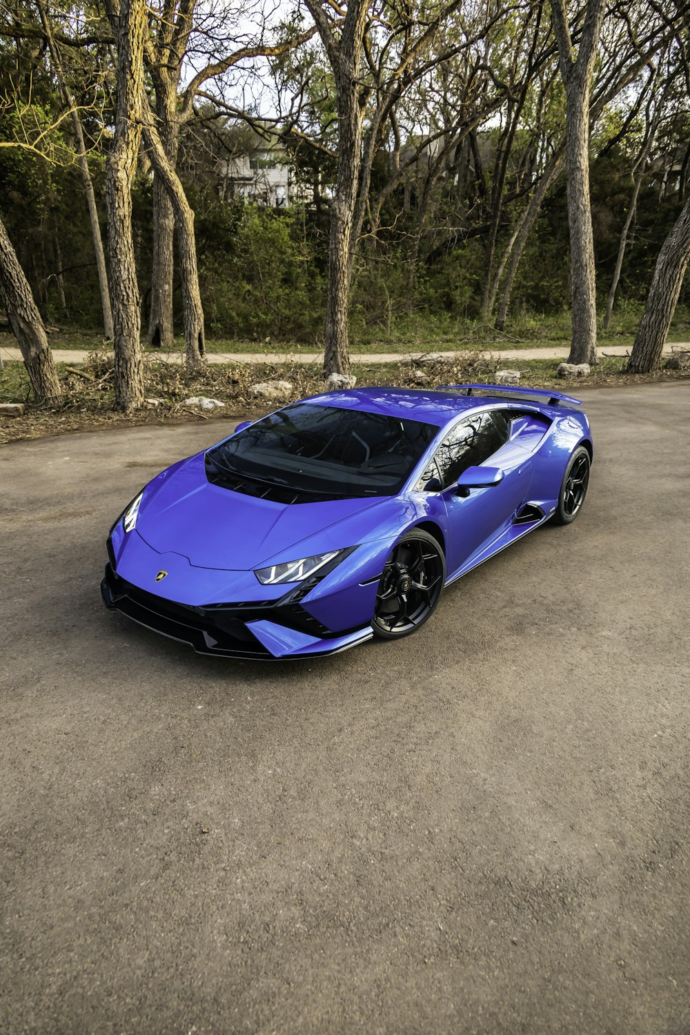 a blue sports car parked in a parking lot