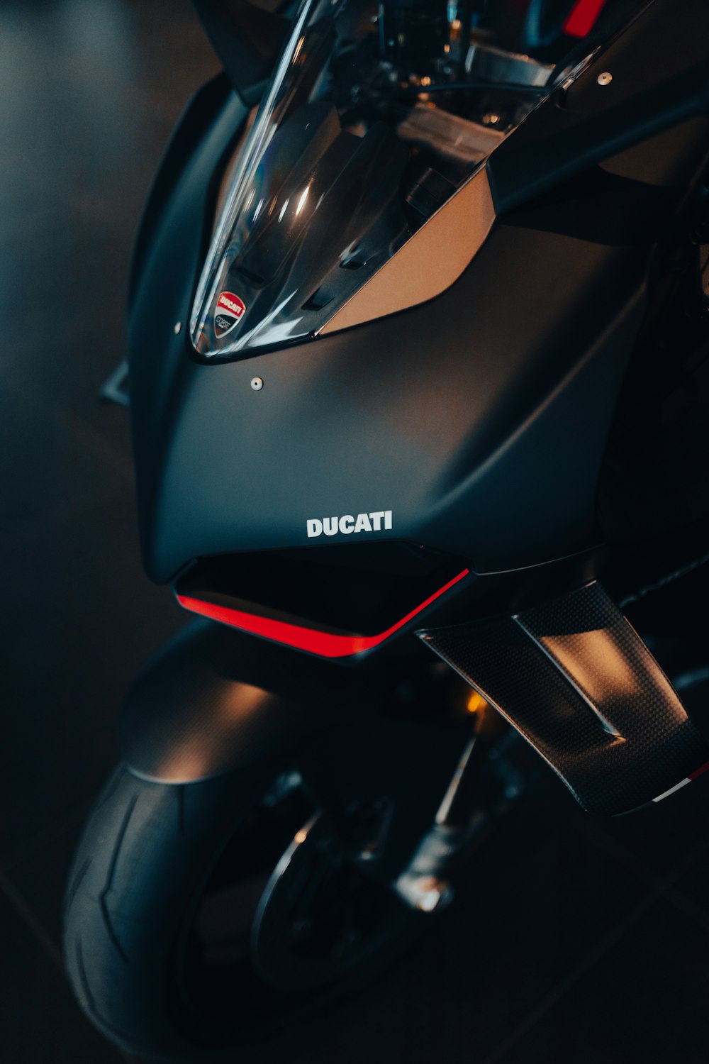 a close up of a motorcycle on a black floor