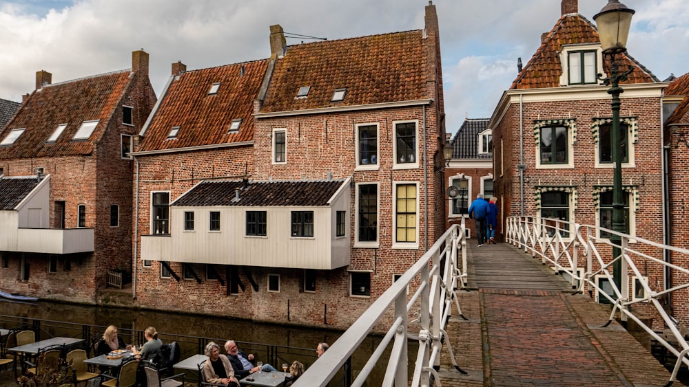 a group of people sitting at tables on a bridge