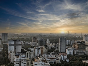 a city with tall buildings and a bridge in the distance