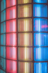 a close up of a multi colored glass block wall