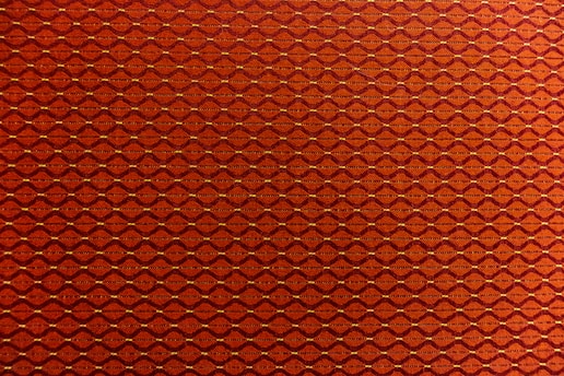 A close-up of the o'sullivan tartan fabric with the 'O' compass emblem subtly embroidered, symbolizing heritage and direction.