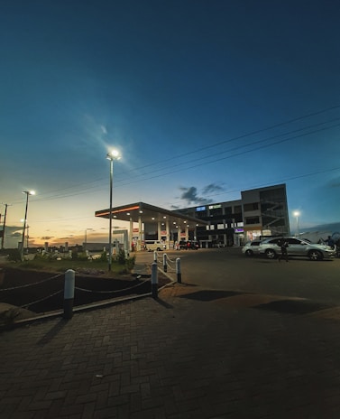 A panoramic shot of the modern Spectra Energies fuel station bustling with vehicles at sunset.