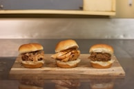 A variety of sandwiches neatly arranged on a rustic wooden board