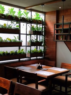 A cozy dining area with a wooden table set for a meal, surrounded by natural decor.