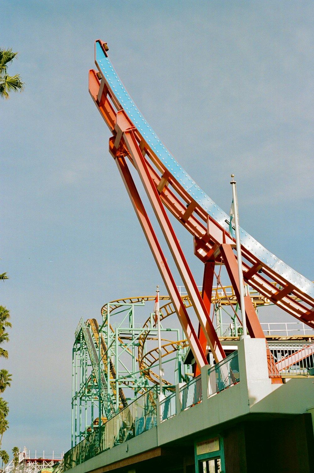 a roller coaster at a theme park with a sky background