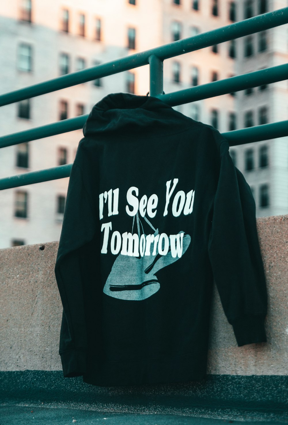 a black hoodie that says i'll see you tomorrow on it