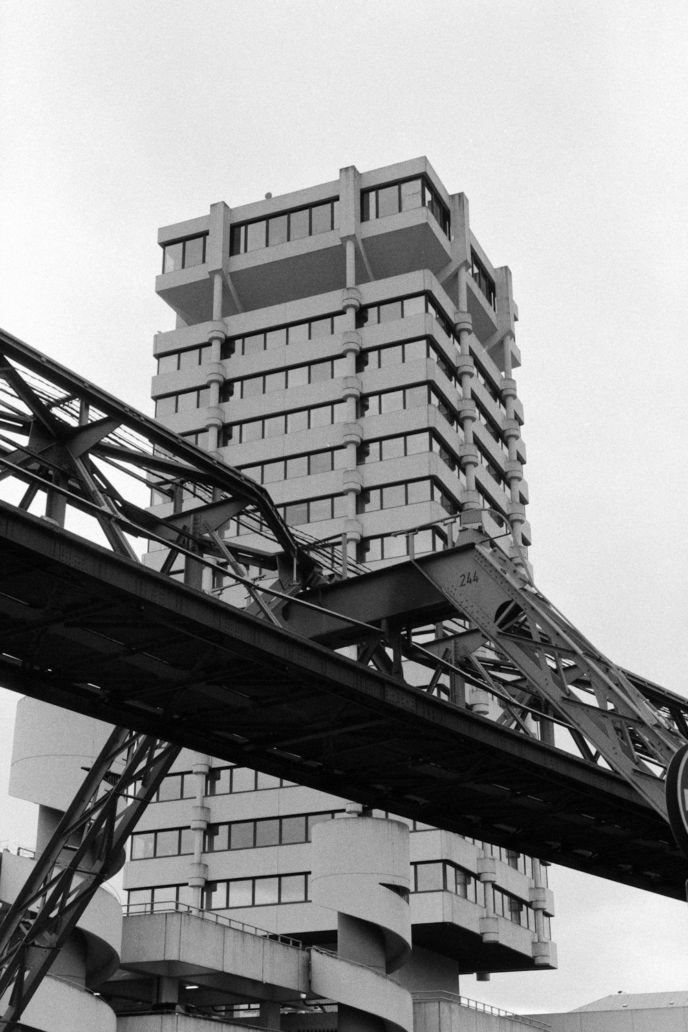 a very tall building sitting next to a bridge