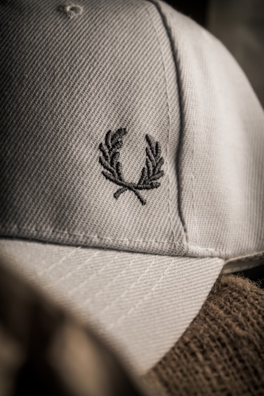 Close-up of a softbrimcap baseball cap showing detailed stitching and fabric texture in natural light.